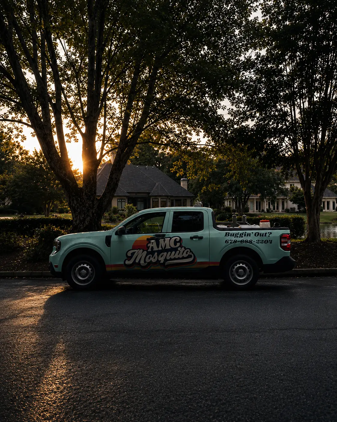 AMC Mosquito’s seafoam truck beneath neighborhood trees in warm, low sunlight.