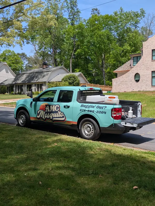 AMC Mosquito service truck on a neighborhood street.
